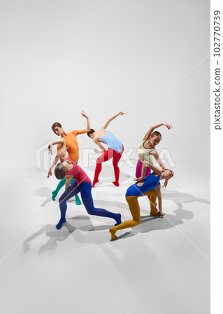 Creative, talented young girls, ballerinas in colorful bright tights dancing against grey studio background. Game of shadows Creative, talented young girls, ballerinas in colorful bright tights dancing against grey studio background. Game of shadows 102770739