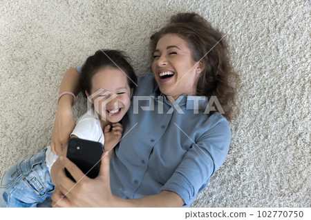 Cheerful young mom hugging happy sweet little kid girl Cheerful young mom hugging happy sweet little kid girl 102770750