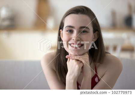 Happy pretty girl in sleeveless cloth leaning chin on hands Happy pretty girl in sleeveless cloth leaning chin on hands 102770973