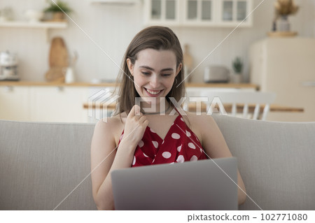 Cheerful beautiful student girl studying on Internet from home 102771080