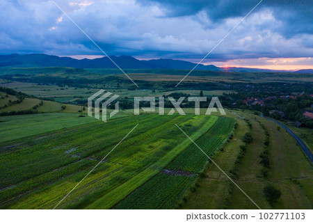 Aerial view of a storm and clouds above a village 102771103