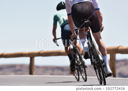 Couple men, road cycling on race bike outdoor in nature Couple men, road cycling on race bike outdoor in nature 102772416