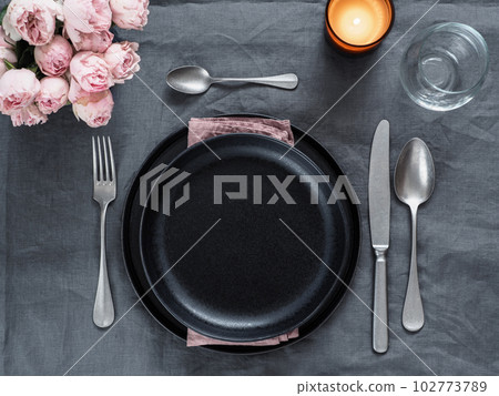 Beautiful table setting on gray linen tablecloth 102773789