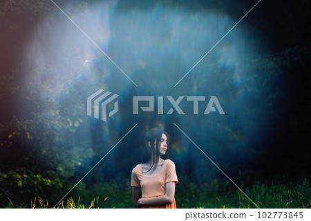 Holistic and Integrative Medicine. Mind-Body Therapies, relaxation techniques. Outdoor portrait of Young woman in nature background with reflection 102773845