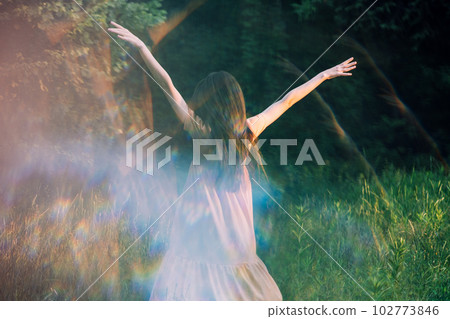 Moments of stillness. moments of self-care and self-soothing. Healing rituals and meditation. Dance Movement Therapy. Young woman dancing in nature background with reflection Moments of stillness. moments of self-care and self-soothing. Healing rituals and meditation. Dance Movement Therapy. Young woman dancing in nature background with reflection 102773846