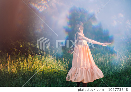 Moments of stillness. moments of self-care and self-soothing. Healing rituals and meditation. Dance Movement Therapy. Young woman dancing in nature background with reflection Moments of stillness. moments of self-care and self-soothing. Healing rituals and meditation. Dance Movement Therapy. Young woman dancing in nature background with reflection 102773848