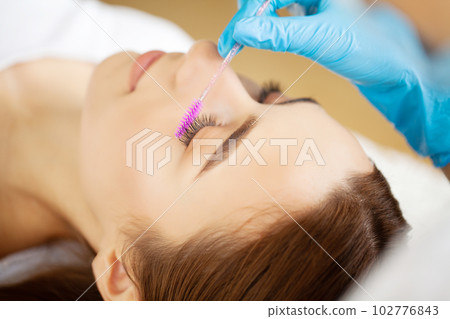 Woman with strong white teeth looking at camera and smiling 102776843