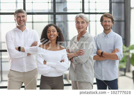 A group of young modern people in smart casual clothes, studying while working in the office A group of young modern people in smart casual clothes, studying while working in the office 102777028
