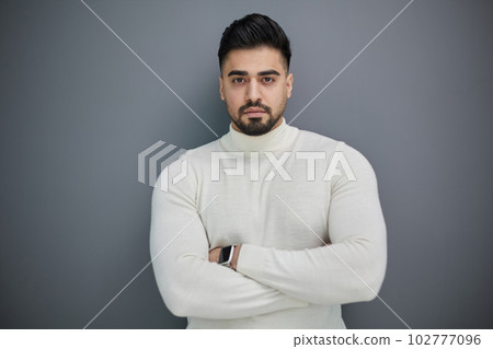 Portrait of stylish middle aged man posing on gray background 102777096