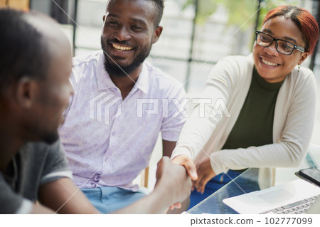 african business people handshaking at modern office african business people handshaking at modern office 102777099