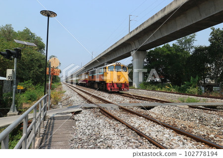 A train running on the outskirts of Bangkok, Thailand A train running on the outskirts of Bangkok, Thailand 102778194