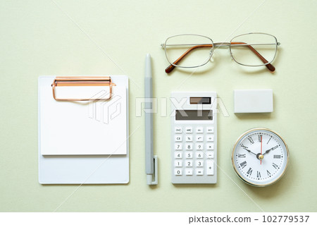 Clipboard, pen, clock, eyeglasses, calculator, eraser on mint desk background. study and workspace. flat lay, top view, copy space 102779537
