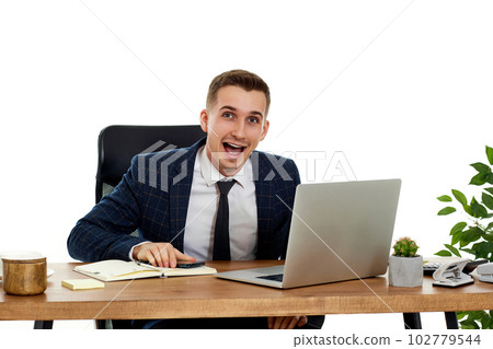 Upset angry businessman after talking on the phone, using laptop 102779544