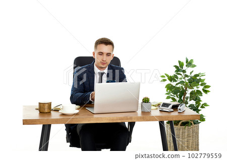 young man using laptop computer for online work at table 102779559