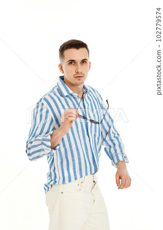 handsome young man in sunglasses and blue striped shirt handsome young man in sunglasses and blue striped shirt 102779574