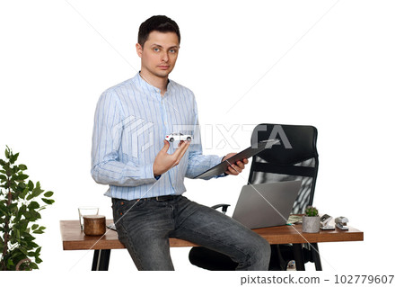 Successful caucasian businessman holding a toy car Successful caucasian businessman holding a toy car 102779607