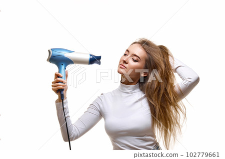 Portrait of attractive cheerful girl drying long hair Portrait of attractive cheerful girl drying long hair 102779661