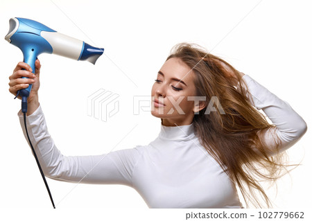 Portrait of attractive cheerful girl drying long hair Portrait of attractive cheerful girl drying long hair 102779662