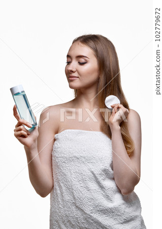 beautiful young woman holding bottle with tonic 102779672