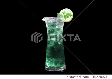 Blue Lagoon or Blue Hawaii Cocktail - A summer alcoholic drink with vodka, tonic, and water on black background, selective focus, soft focus. Blue Lagoon or Blue Hawaii Cocktail - A summer alcoholic drink with vodka, tonic, and water on black background, selective focus, soft focus. 102780719