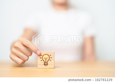 hand hold lightbulb  block with business Idea, strategy, innovation , creativity, learning, brainstorming  and success concept hand hold lightbulb  block with business Idea, strategy, innovation , creativity, learning, brainstorming  and success concept 102781229