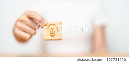hand hold lightbulb  block with business Idea, strategy, innovation , creativity, learning, brainstorming  and success concept hand hold lightbulb  block with business Idea, strategy, innovation , creativity, learning, brainstorming  and success concept 102781230