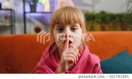 Child kid girl presses finger to lips makes silence hush sign do not tells gossip secret, quiet Child kid girl presses finger to lips makes silence hush sign do not tells gossip secret, quiet 102781891