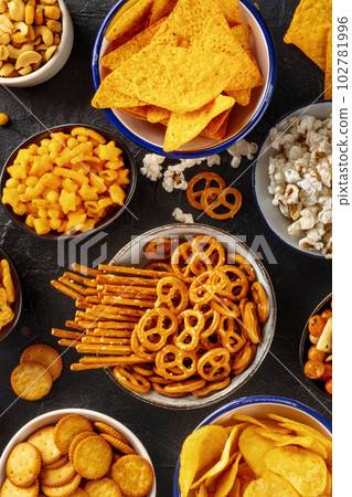 Salty snacks, party mix, top shot. A variety of appetizers in bowls Salty snacks, party mix, top shot. A variety of appetizers in bowls 102781996