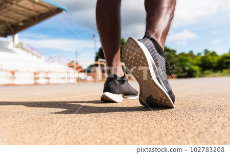 Asian young athlete sport runner black man wear feet active ready to running training at the outdoor on the treadmill line road for a step forward, healthy exercise workout, closeup back shoe 102783208