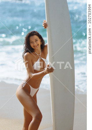 A Sunny Day of Surfing and Smiles of Bikini Beach Girl A Sunny Day of Surfing and Smiles of Bikini Beach Girl 102783994