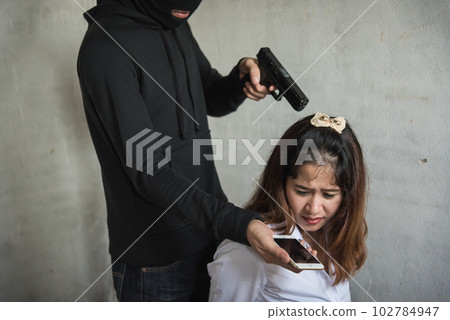 Man with gun threaten woman for call money hostage, robber concept Man with gun threaten woman for call money hostage, robber concept 102784947