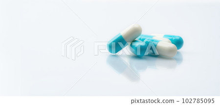 Blue-white capsule pills on white background. Pharmacy banner. Prescription drug. Healthcare and medicine. Pharmaceutical industry. Pharmaceutical science. Drug safety. Prescription medication. 102785095