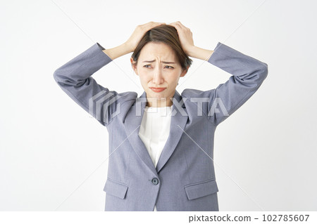 Business woman holding her head White background 102785607