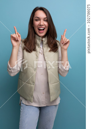 joyful successful brunette young woman in casual look looks up joyful successful brunette young woman in casual look looks up 102786075