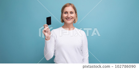 panoramic photo of blonde middle aged woman in white sweater with money card mockup 102786090