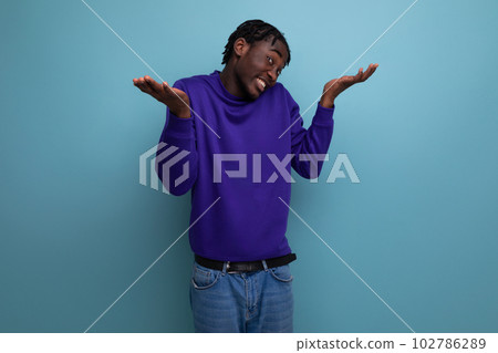 portrait of frustrated african american young adult in jeans isolated on plain background 102786289