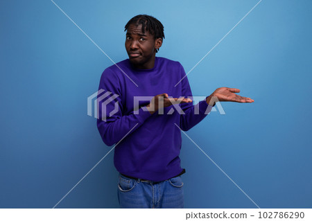 emotional thinking black american young man with dreadlocks in casual clothes 102786290