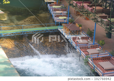 Tables under tents near the water on the Dimchay River in Alanya, Turkey, April 2023. Tables under tents near the water on the Dimchay River in Alanya, Turkey, April 2023. 102788942