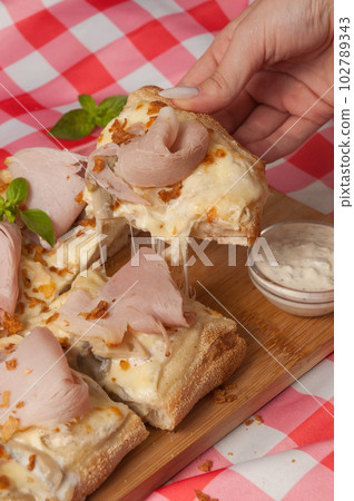tasty cream-based pizza with ham and mushrooms 102789343