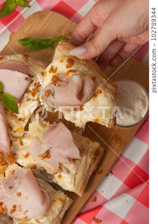 tasty cream-based pizza with ham and mushrooms 102789344