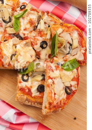 italian vegetarian pizza with zucchini mushrooms olives and cheese 102789355