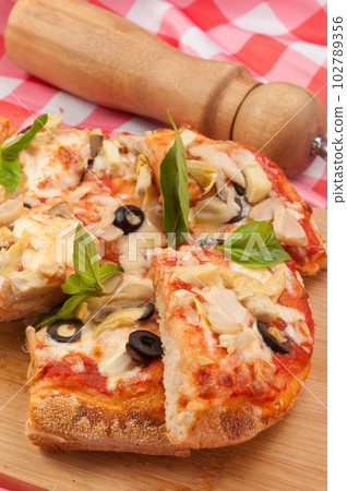 italian vegetarian pizza with zucchini mushrooms olives and cheese 102789356