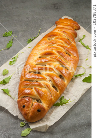 fish and onion pie in the shape of a fish 102789371