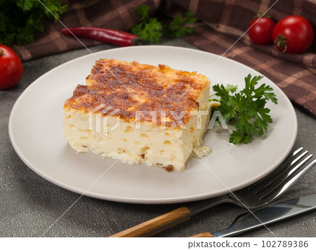 airy homemade omelet with milk and herbs on a gray plate 102789386
