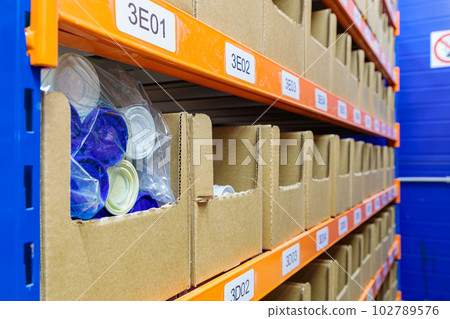 Boxes on racks in a warehouse of goods close-up. 102789576