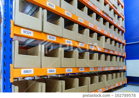 Boxes on racks in a warehouse of goods close-up. 102789578