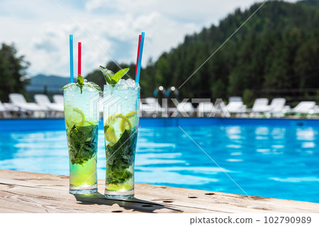 Two Mojito cocktail with lime and mint in highball glass Two Mojito cocktail with lime and mint in highball glass 102790989