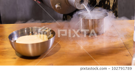 Smoke vapor dry ice in bowl in kitchen copy space and empty space for text Smoke vapor dry ice in bowl in kitchen copy space and empty space for text 102791789
