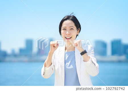 Business woman cheering with a smile Business woman cheering with a smile 102792742