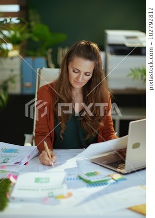 business owner woman in green office working with documents 102792812